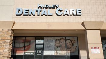 a dental care clinic with a sign that says higley dental care