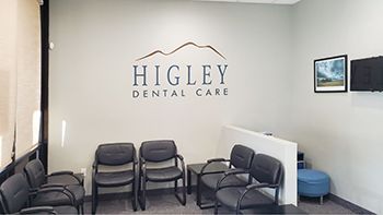 a waiting room with chairs and a sign that says higley dental care .