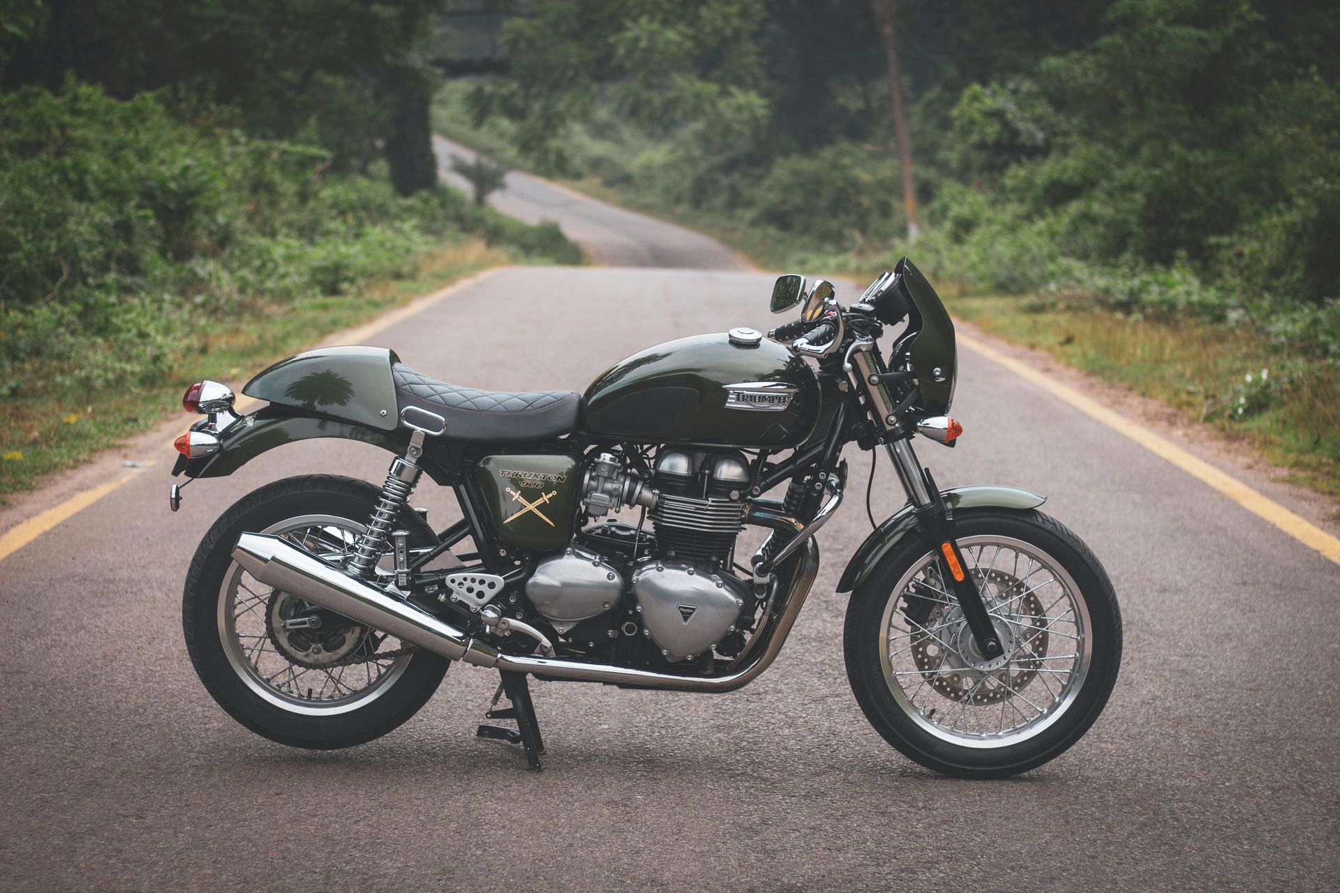 A black motorcycle is parked on the side of a road.