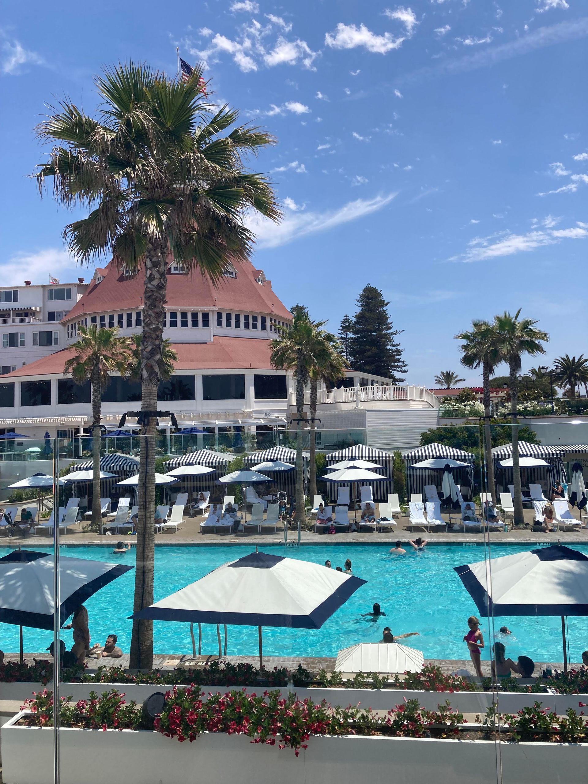 A large swimming pool surrounded by umbrellas and chairs