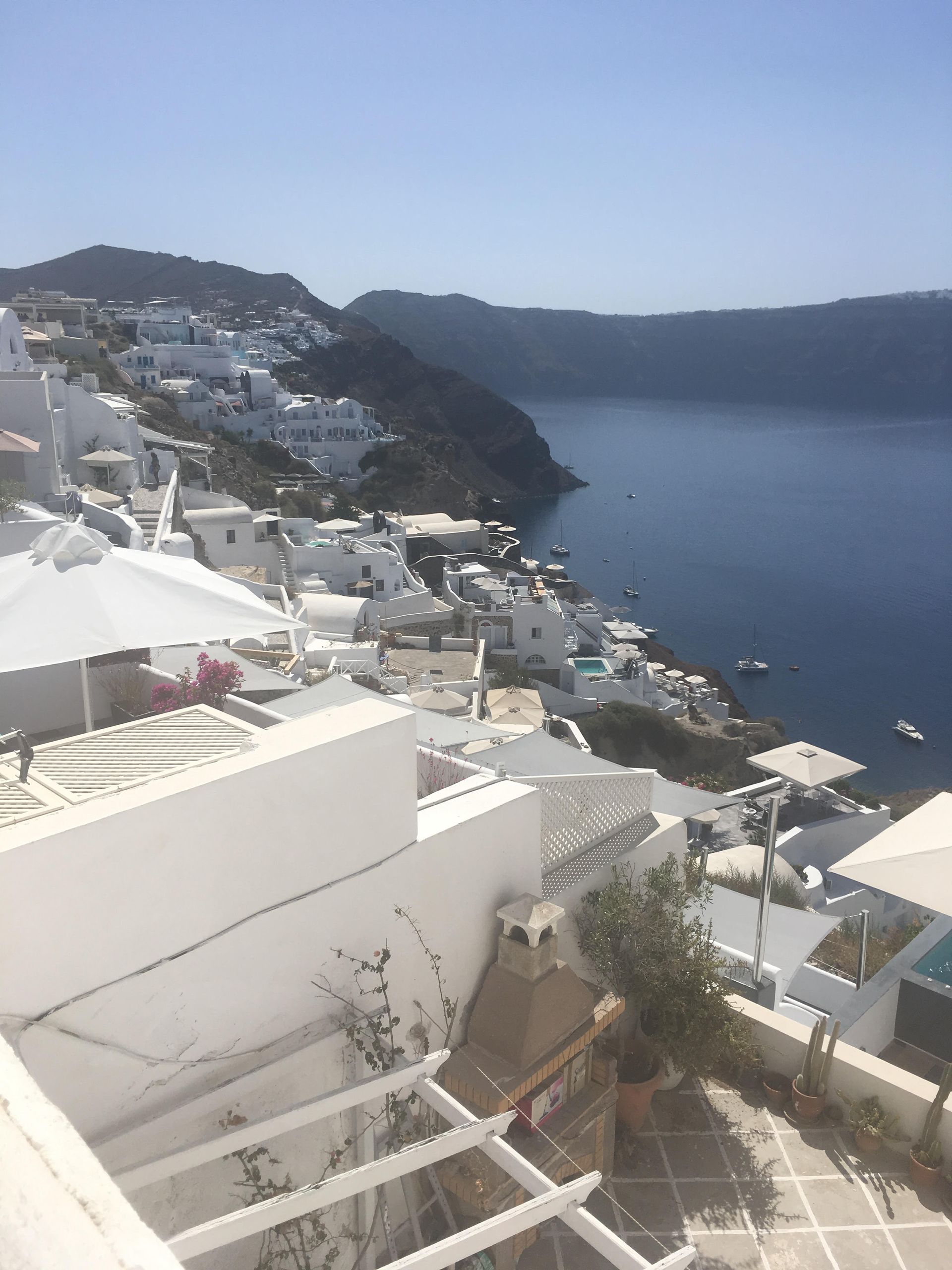 A view of a city from a balcony overlooking a body of water.