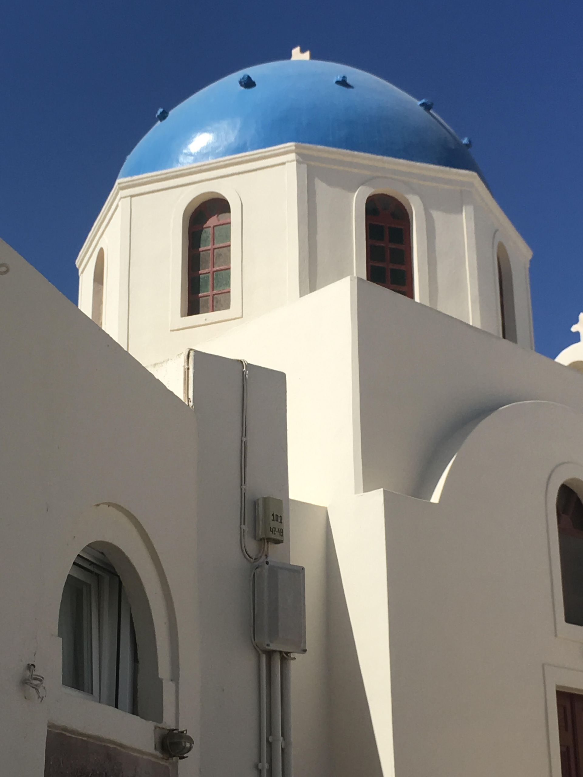 A white building with a blue dome on top