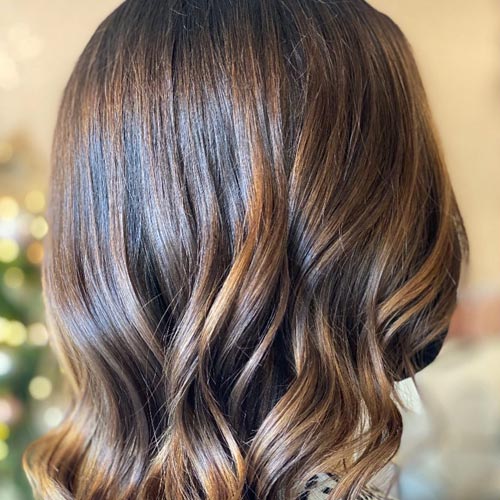 Brown hair, recently dyed, cut and styled