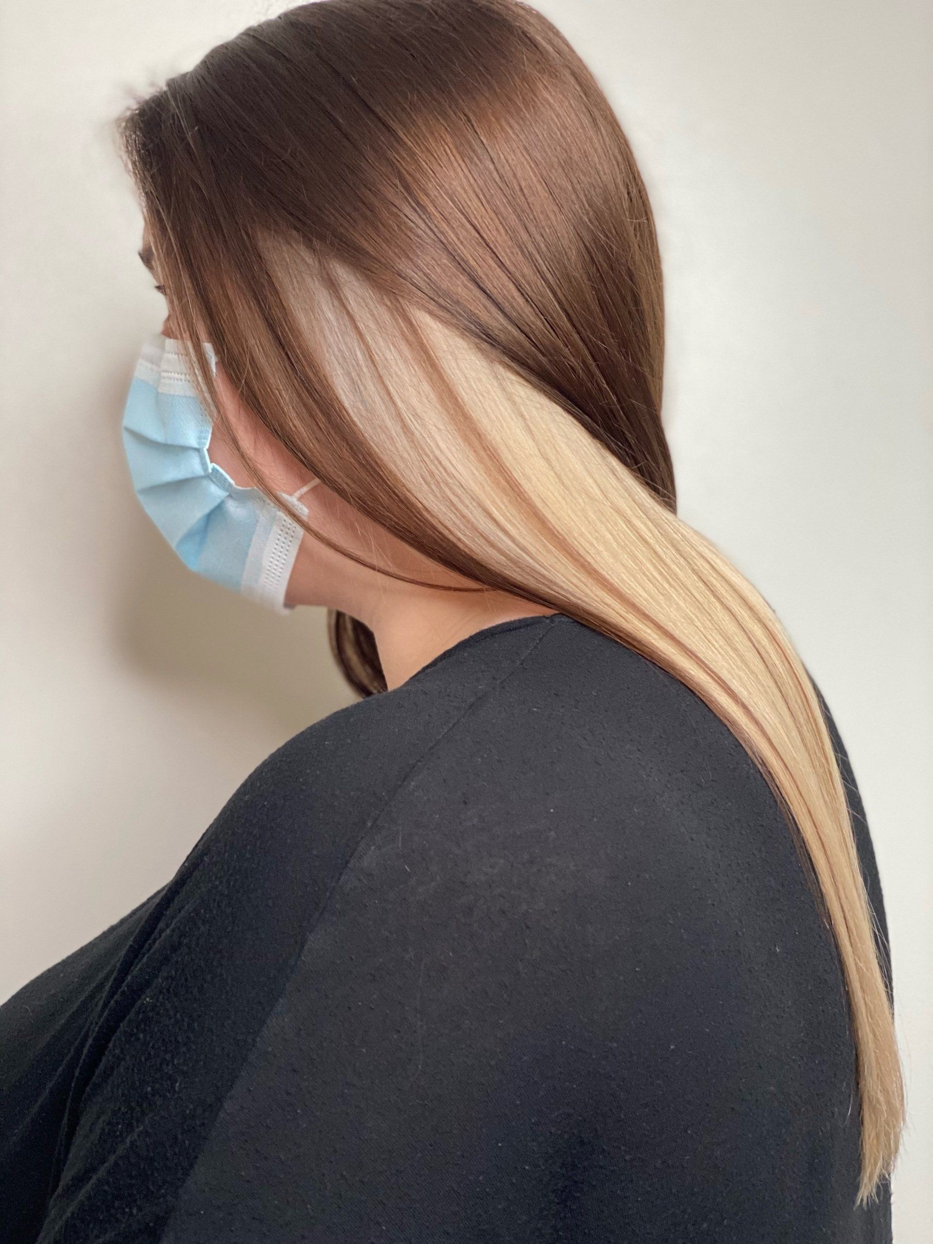 Woman with straight blond highlighted hair, freshly cut and styled