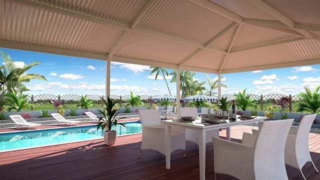 Table and Chairs Under a Canopy Overlooking a Swimming Pool — Downright Carpentry in Ryan, QLD