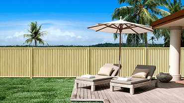 Patio With Chairs and an Umbrella in Front of a Fence — Downright Carpentry in Ryan, QLD