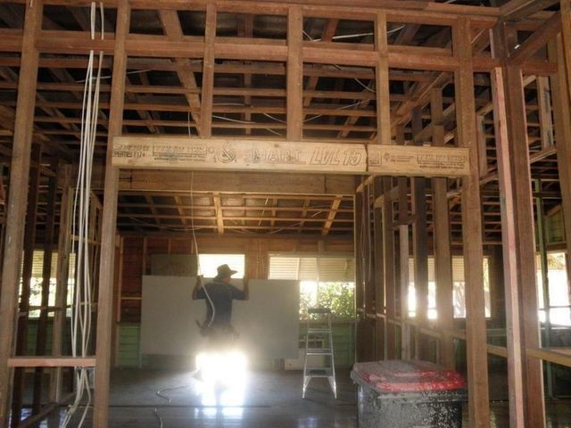 Man is Standing in the Middle of a Building Under Construction — Downright Carpentry in Ryan, QLD