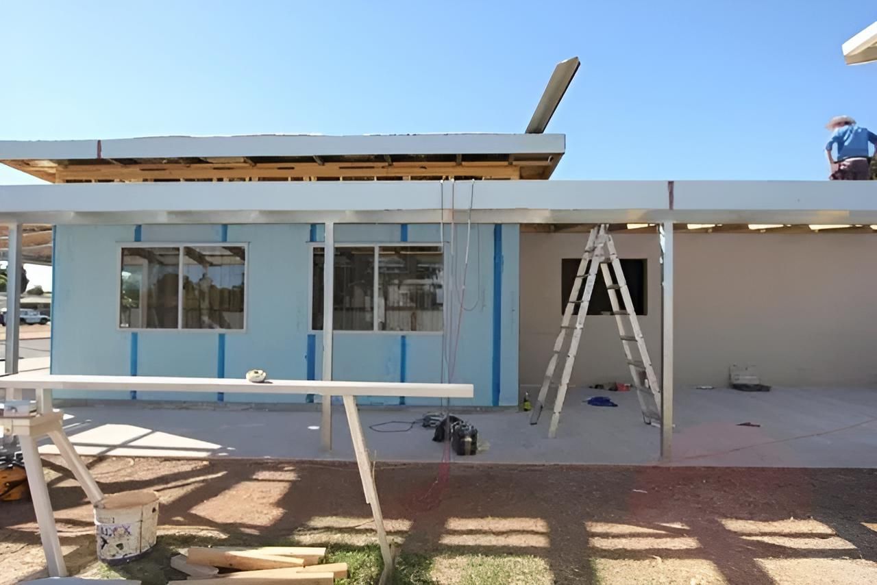 Man is Working on the Roof of a House — Downright Carpentry in Ryan, QLD