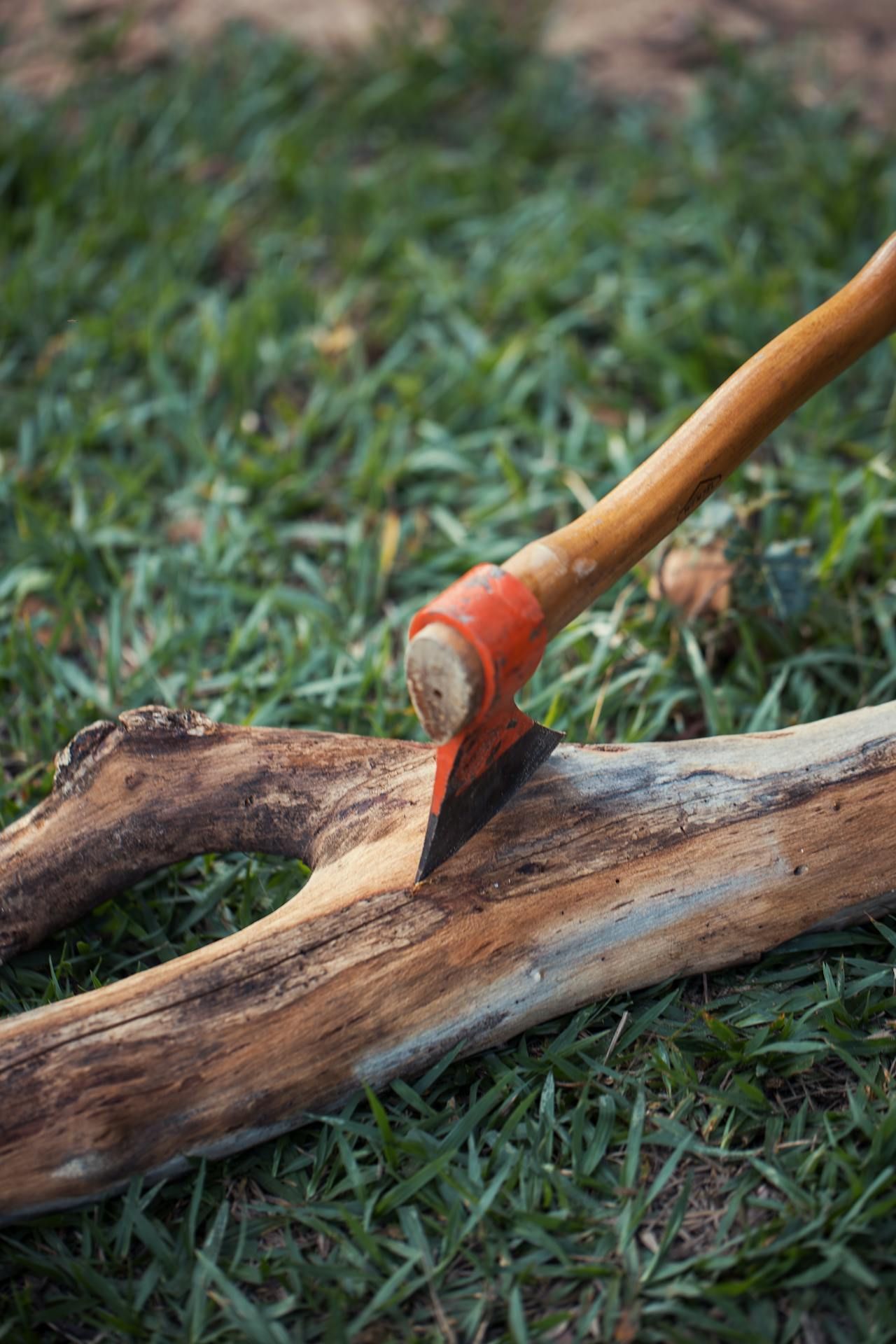 Hand axe embedded into a piece of wood.