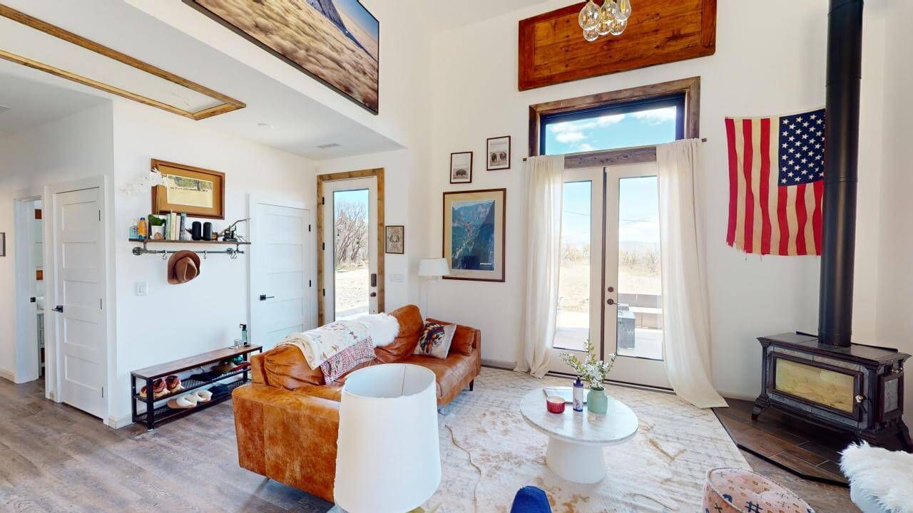 A living room with a couch , table , fireplace and american flag. Maven Construction, Montrose, CO