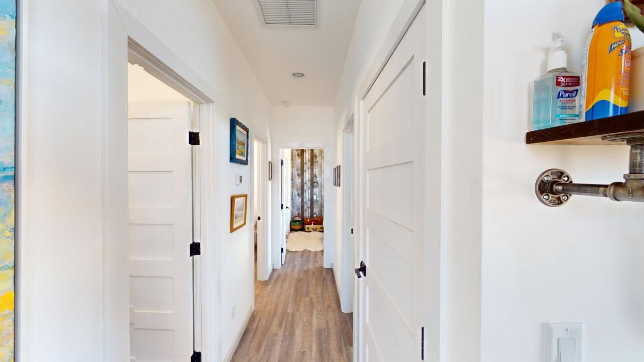 A long hallway in a house with a shelf on the wall. Maven Construction, Montrose, CO