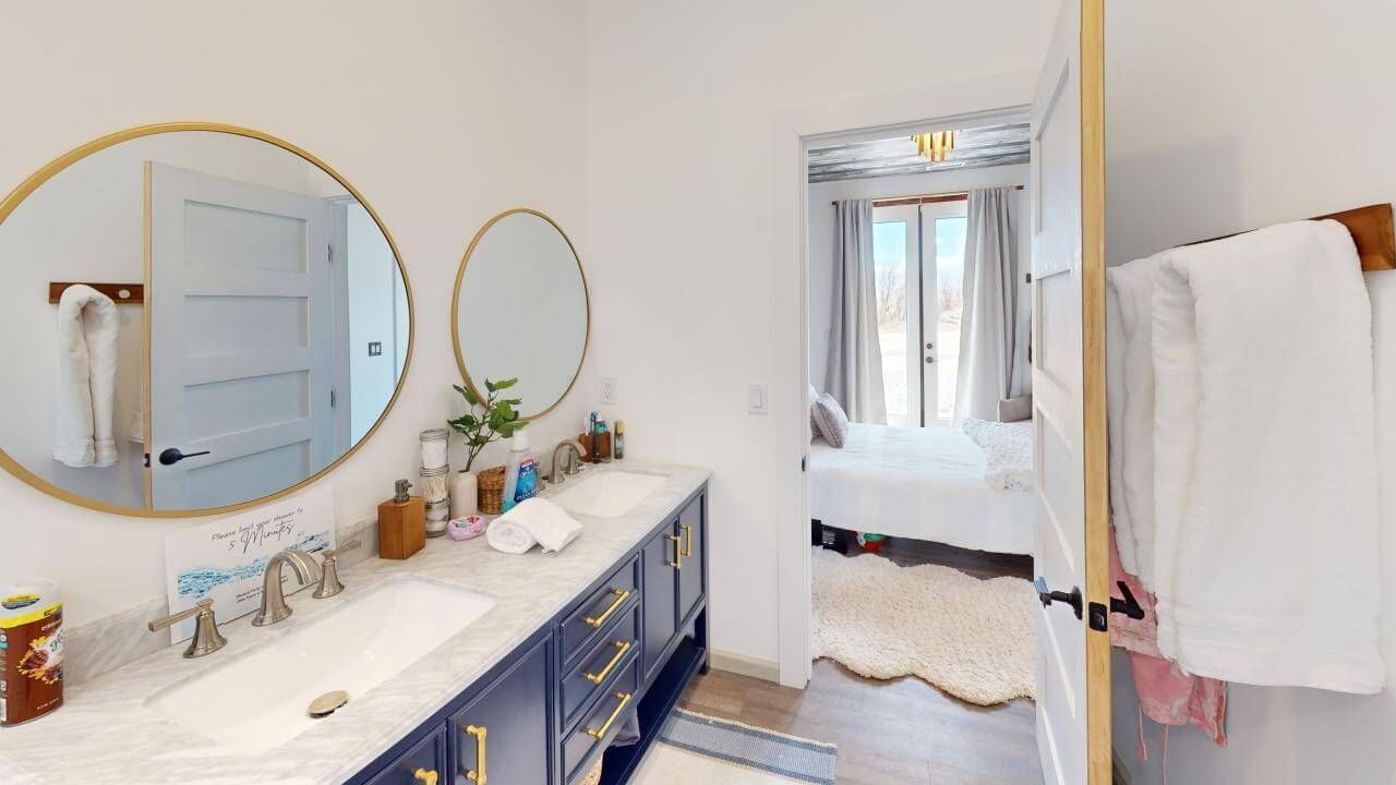 A bathroom with two sinks , two mirrors and a bathtub. Maven Construction, Montrose, CO