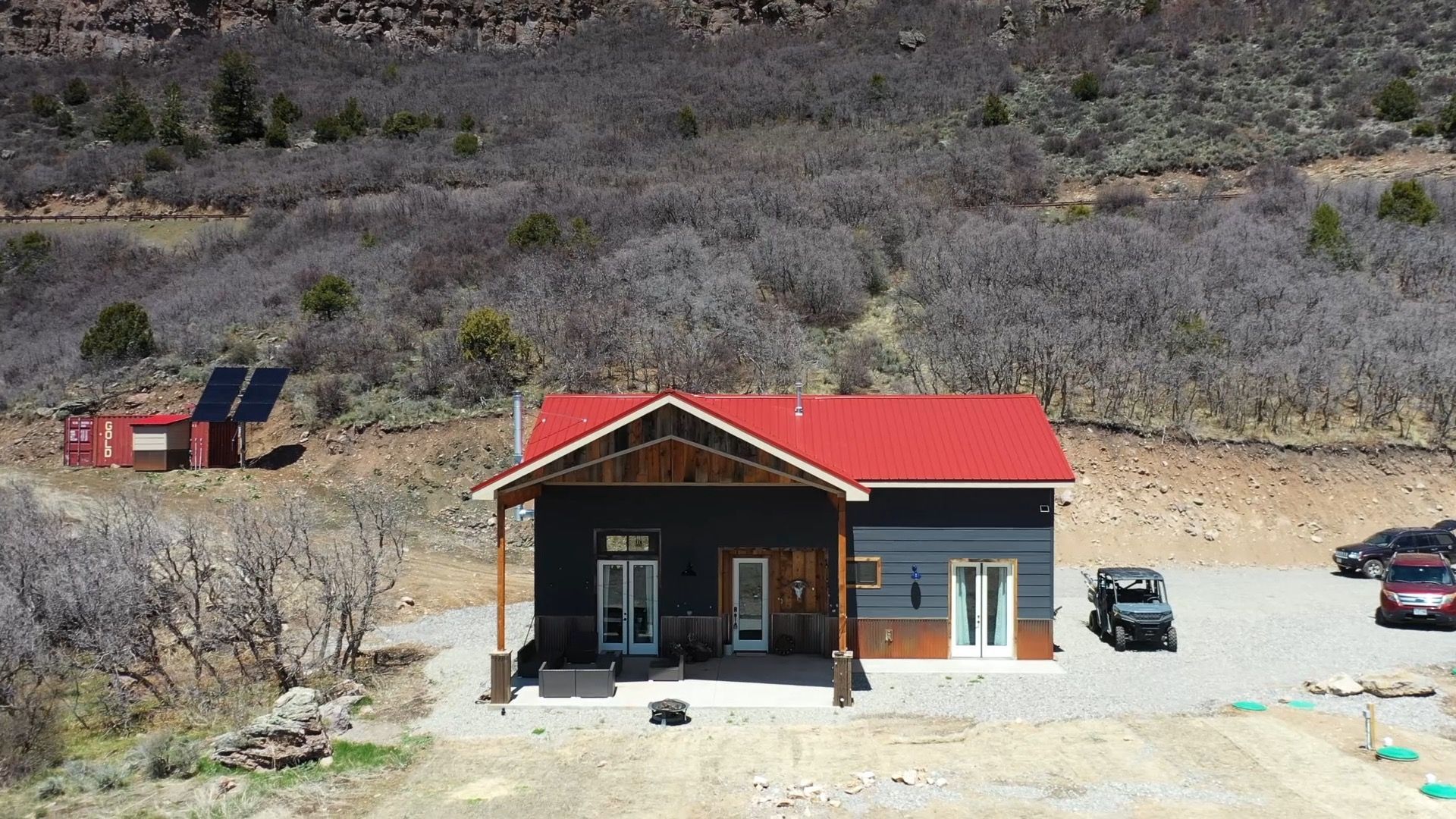 An aerial view of a house with a red roof Maven Construction, Montrose, CO