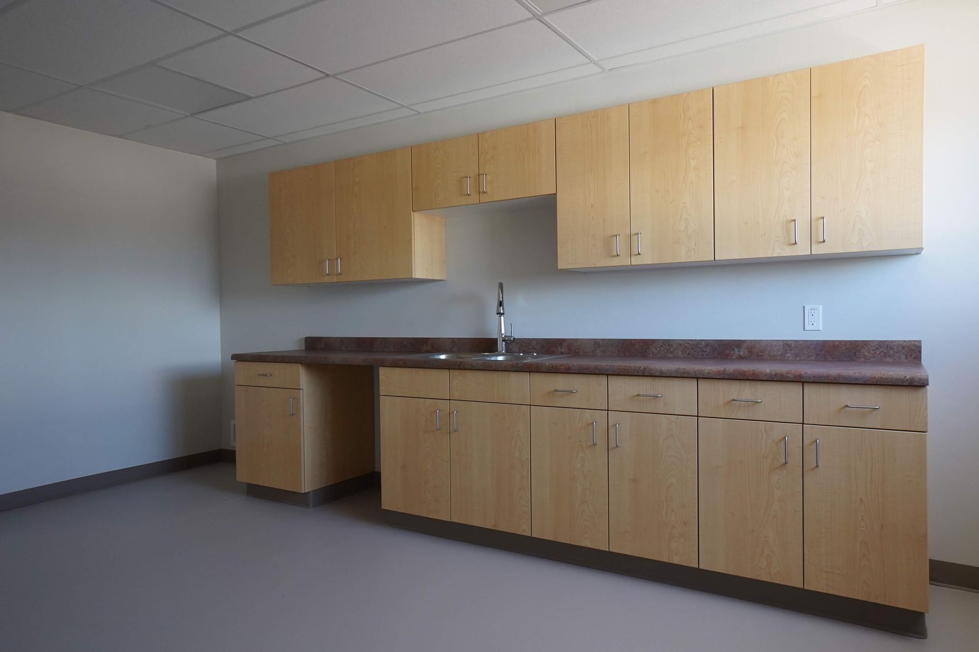 An empty kitchen with wooden cabinets and a sink Maven Construction, Montrose, CO