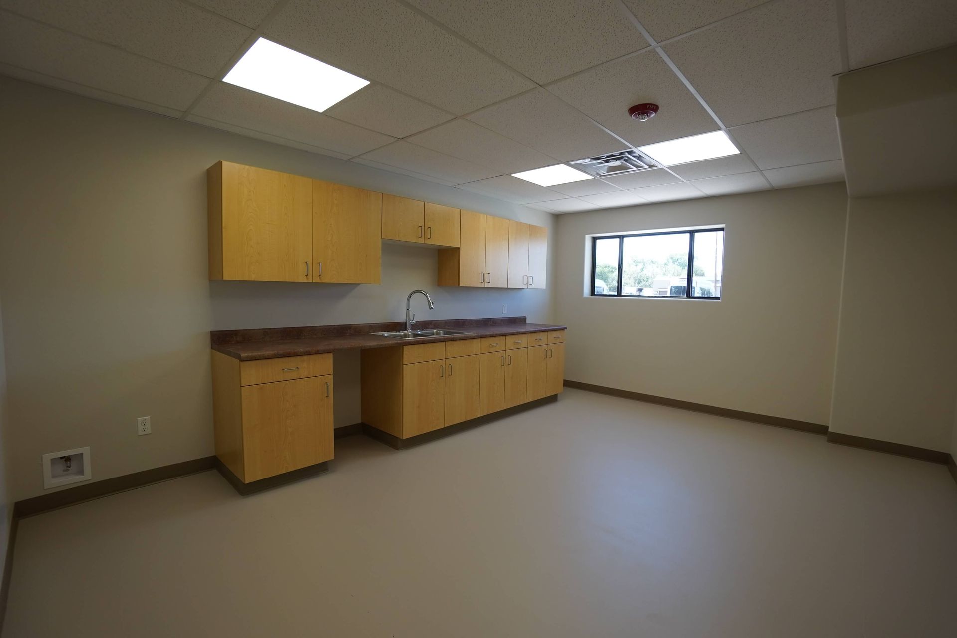 An empty kitchen with wooden cabinets and a sink Maven Construction, Montrose, CO