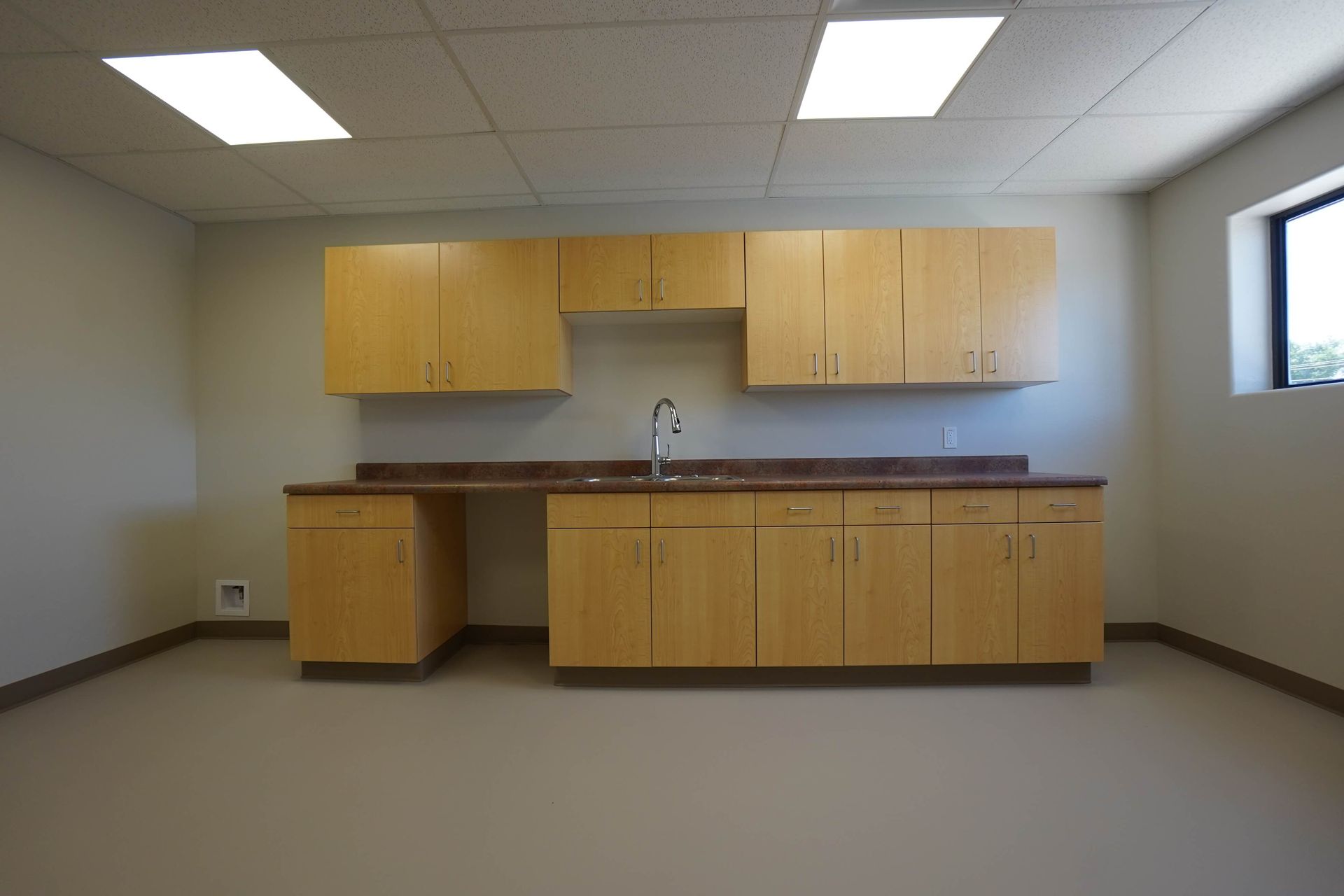 An empty kitchen with wooden cabinets and a sink Maven Construction, Montrose, CO