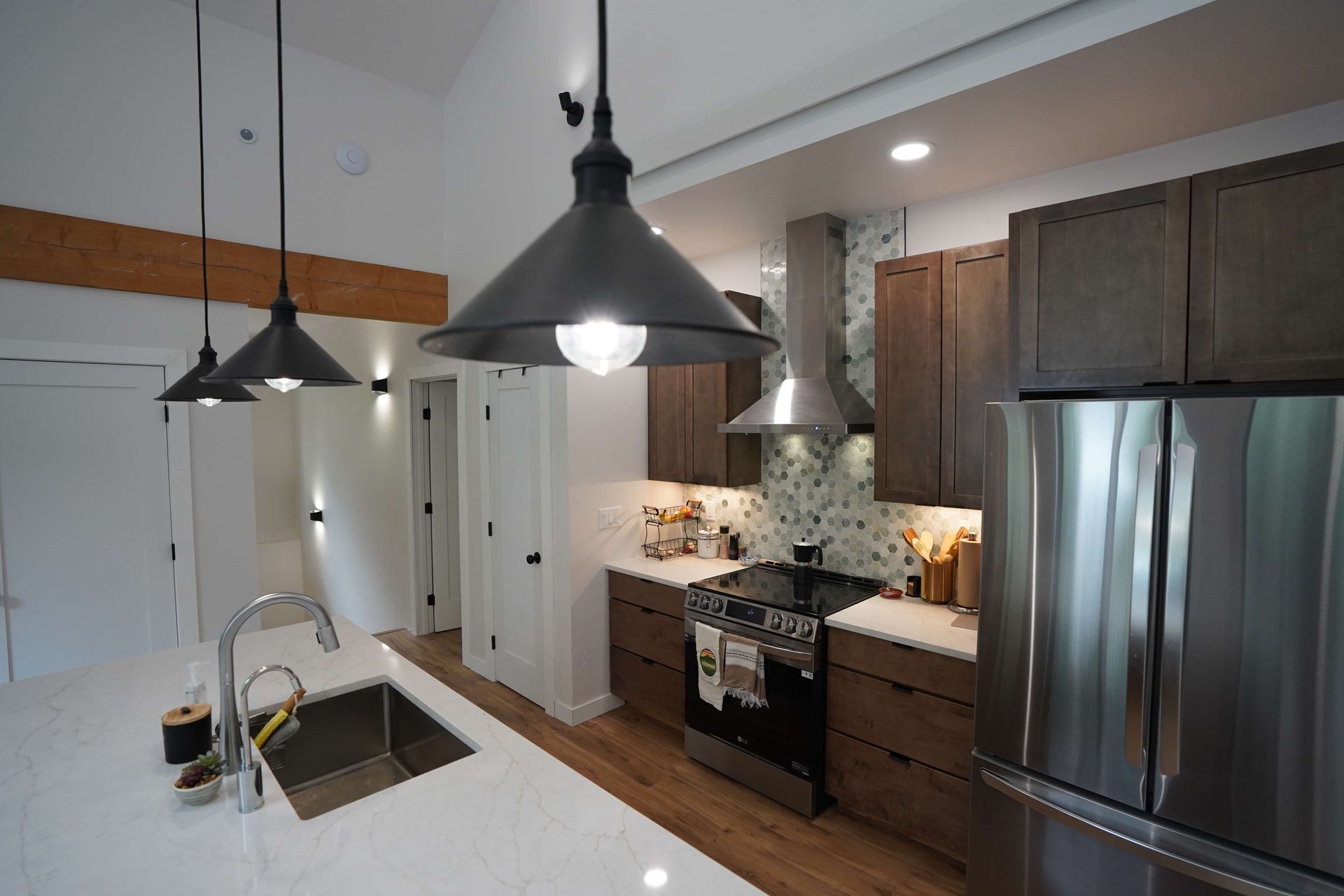A kitchen with stainless steel appliances and wooden cabinets