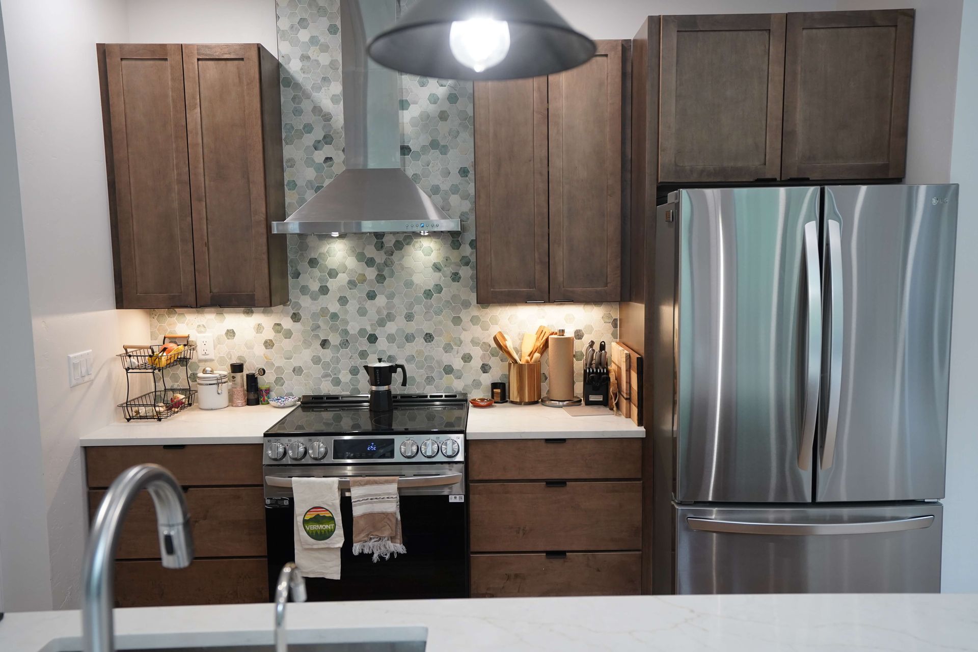 A kitchen with stainless steel appliances and wooden cabinets