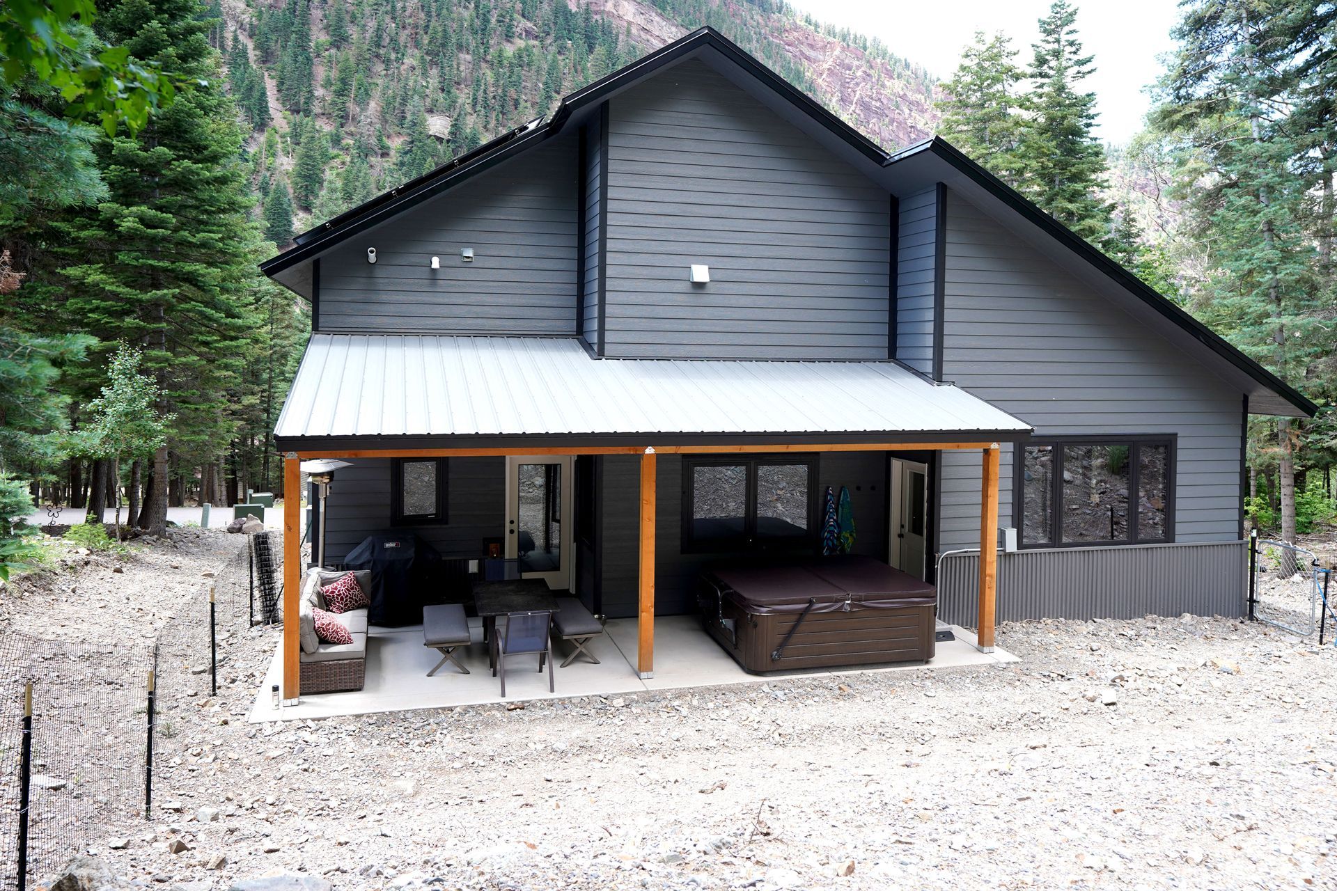 A large gray house with a hot tub on the porch Maven Construction, Montrose, CO