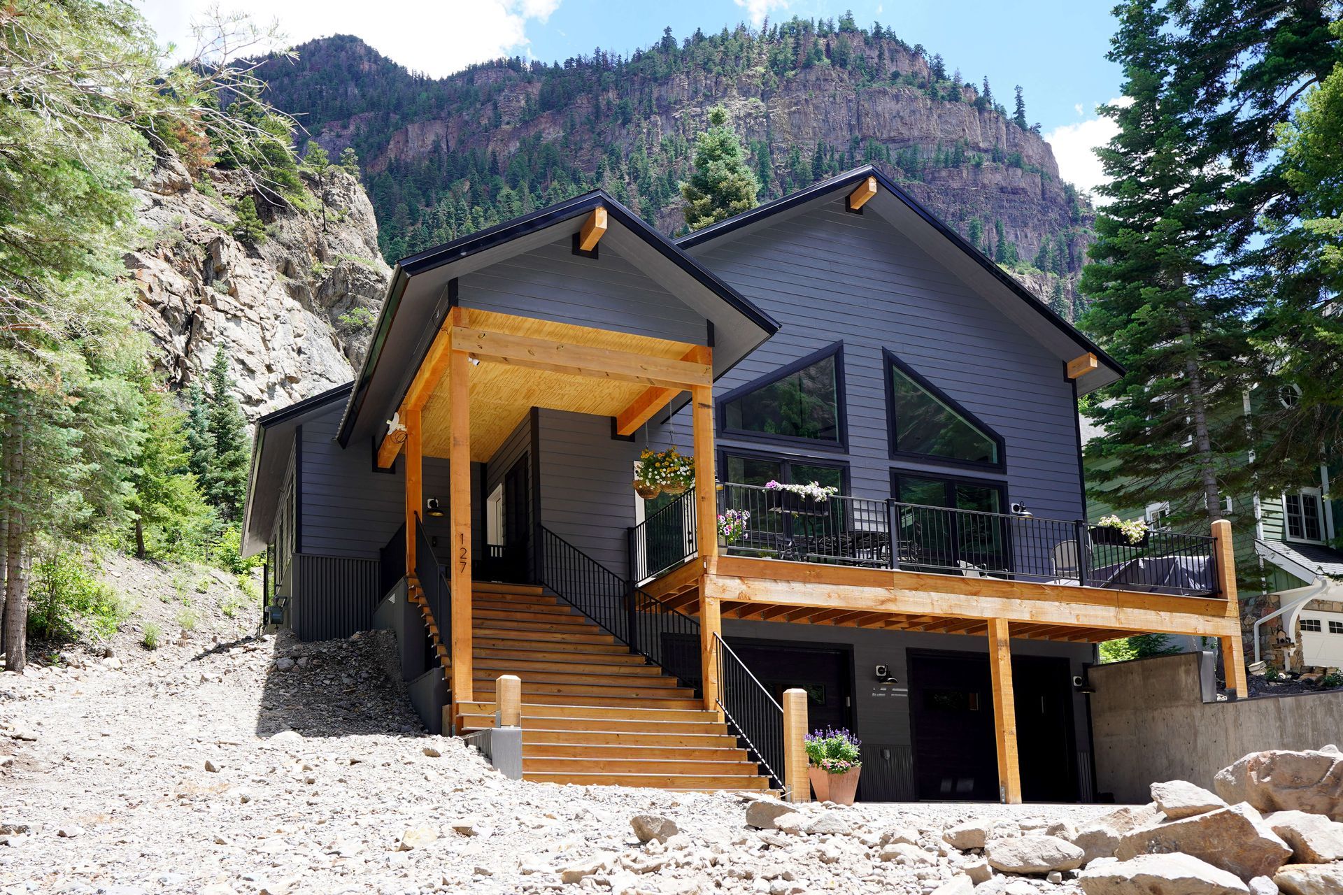 A house with a large deck and stairs leading up to it Maven Construction, Montrose, CO