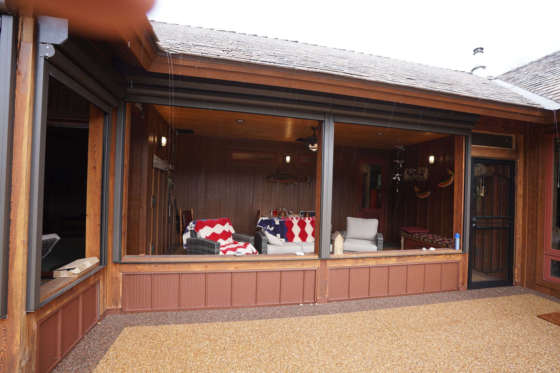 A large screened in porch with a couch and chairs on it. Maven Construction, Montrose, CO