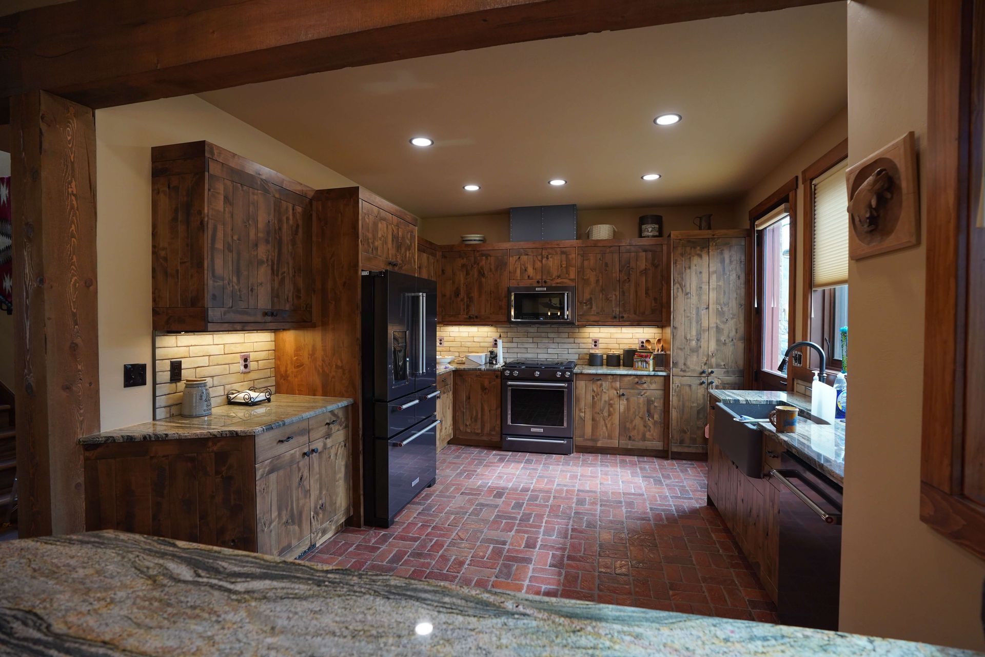 A kitchen with wooden cabinets and granite counter tops Maven Construction, Montrose, CO