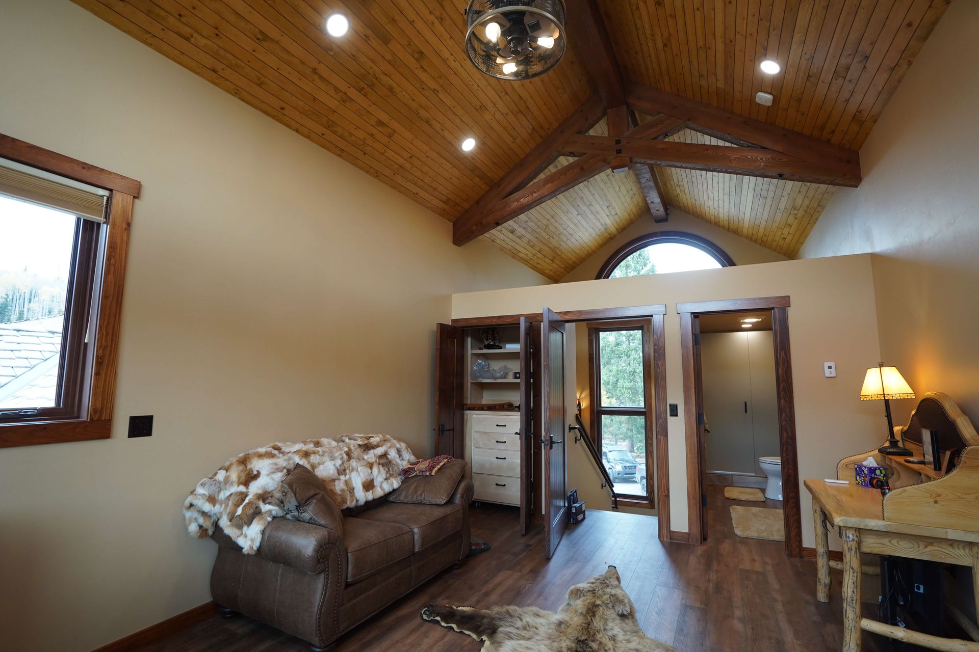 A living room with a vaulted ceiling and a couch Maven Construction, Montrose, CO
