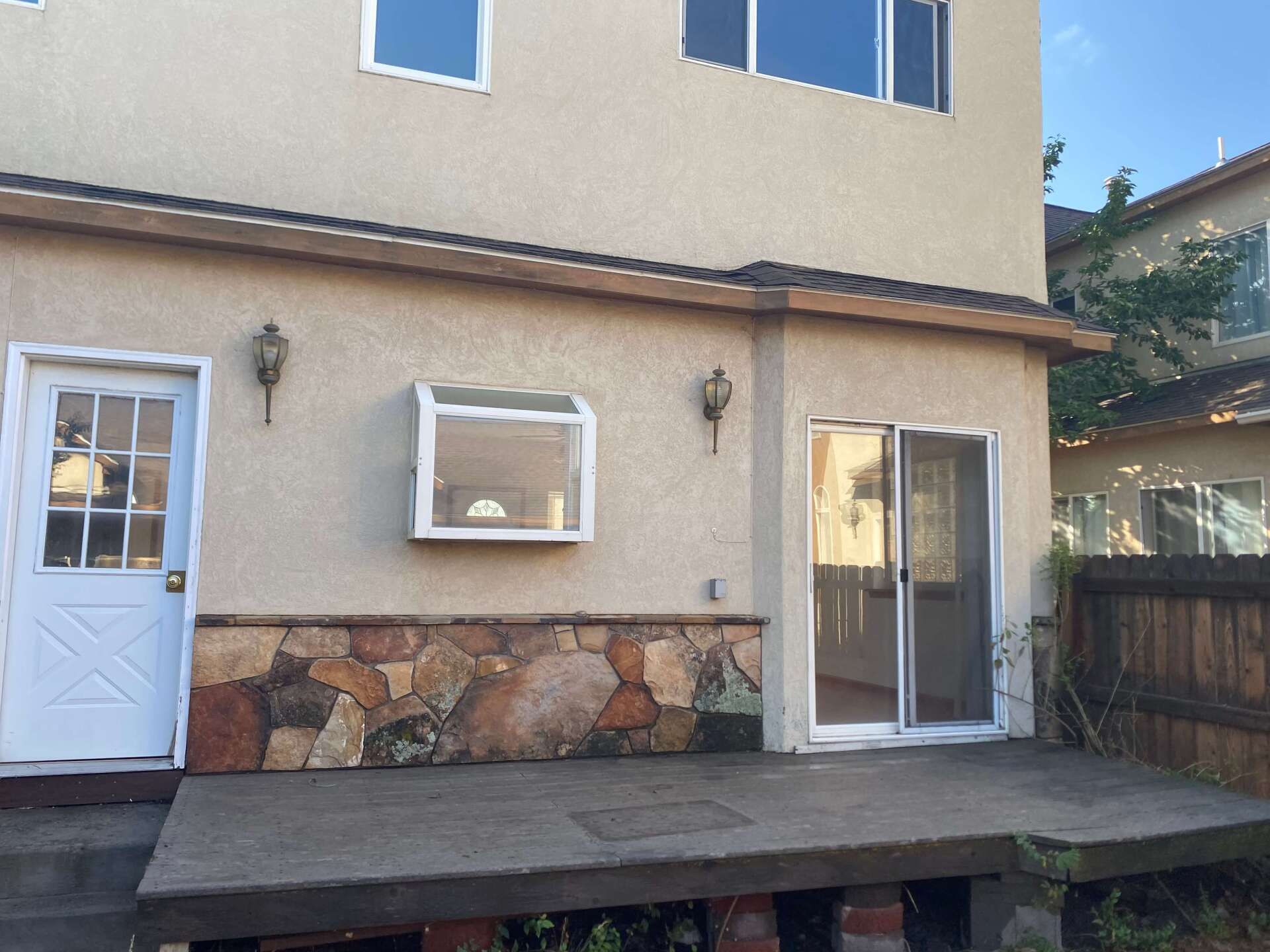 The back of a house with a sliding glass door Maven Construction, Montrose, CO