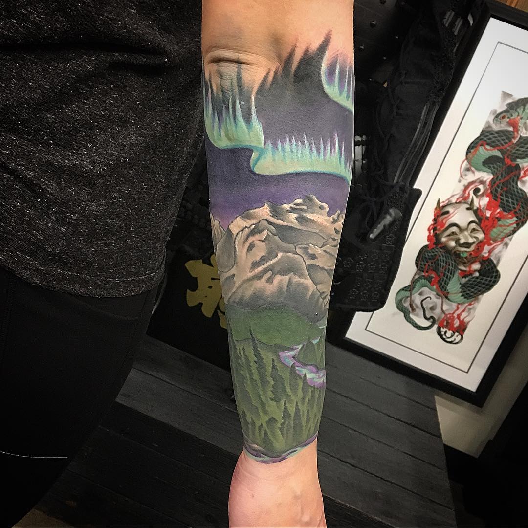 Northern Lights and Mountain Scenery Tattoo by Dale Moostoos at Crimson Empire Tattoo in Edmonton Alberta Canada