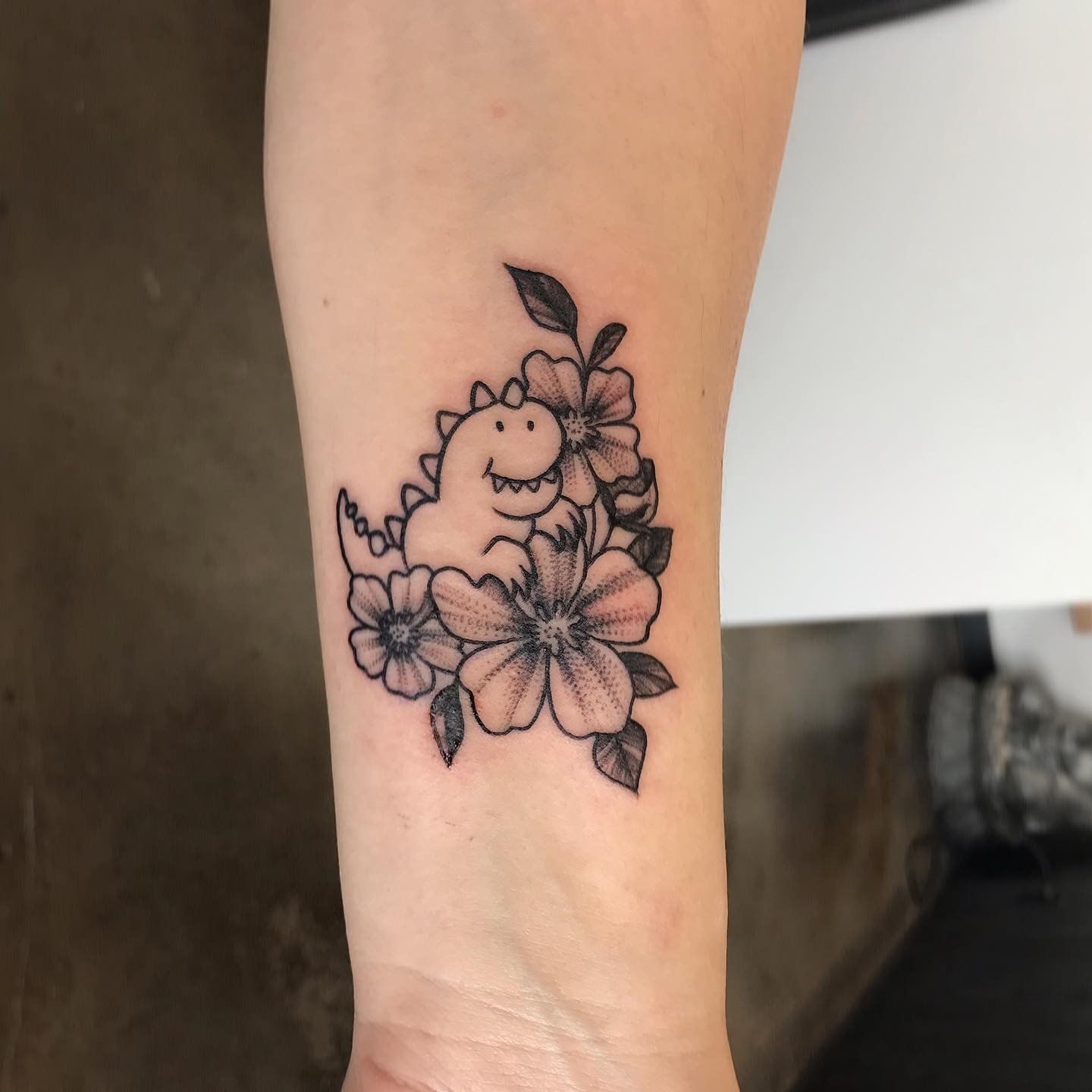 Dinosaur and Floral Tattoo Adrienne Alexander at Crimson Empire Tattoo in Edmonton Alberta Canada