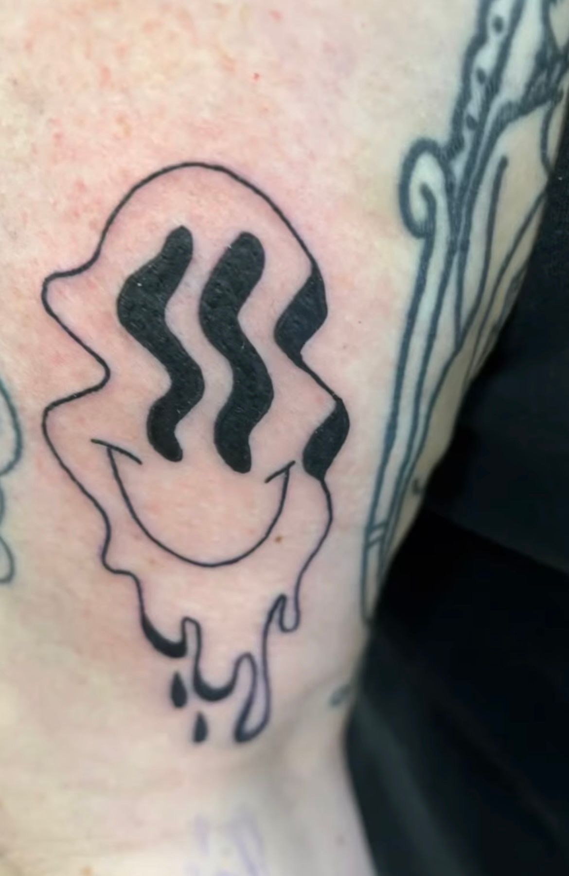 Smiley Tattoo by Keon Courtney at Crimson Empire Tattoo in Edmonton Alberta Canada