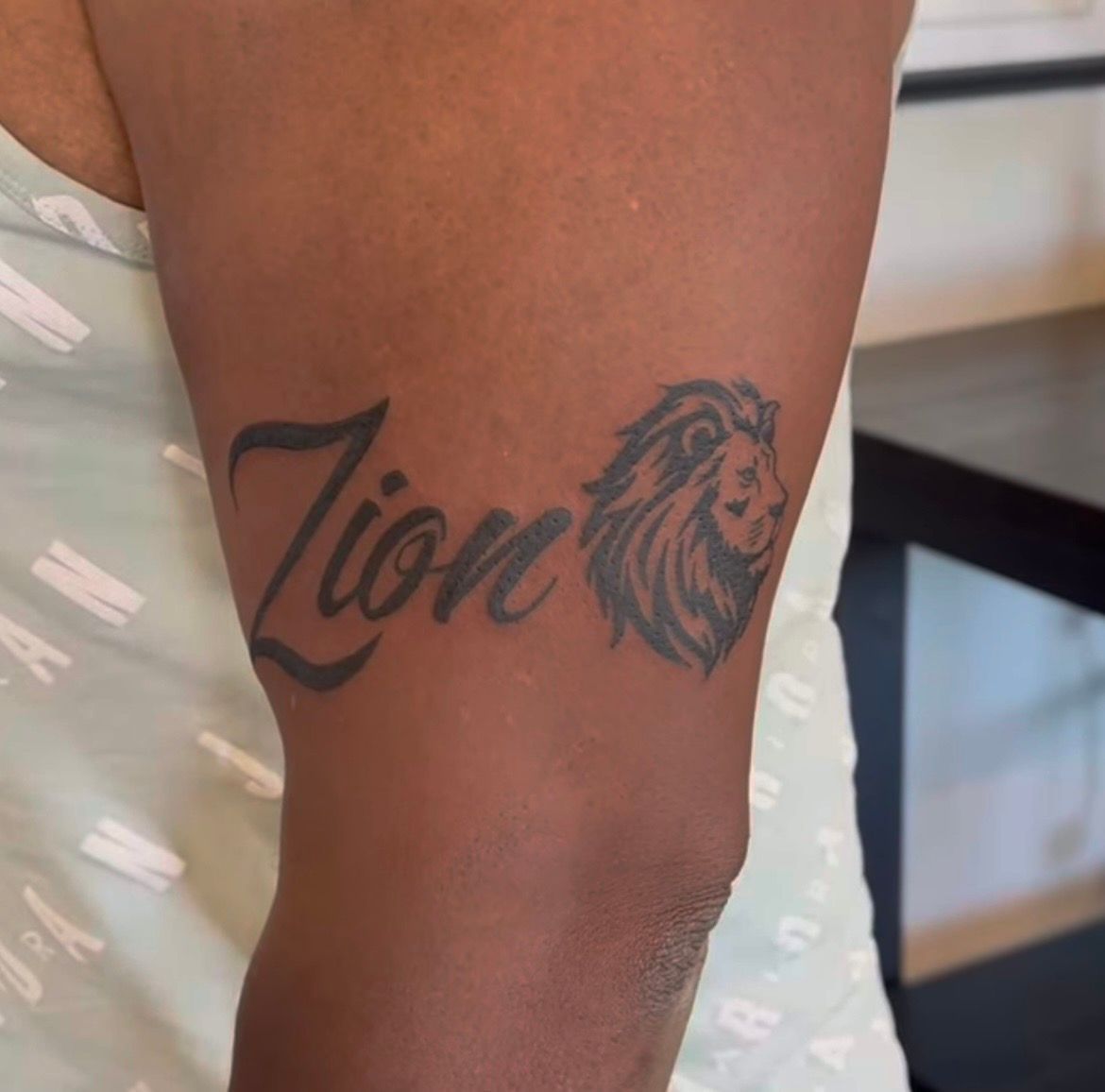 Lion and Script Tattoo by Keon Courtney at Crimson Empire Tattoo in Edmonton Alberta Canada