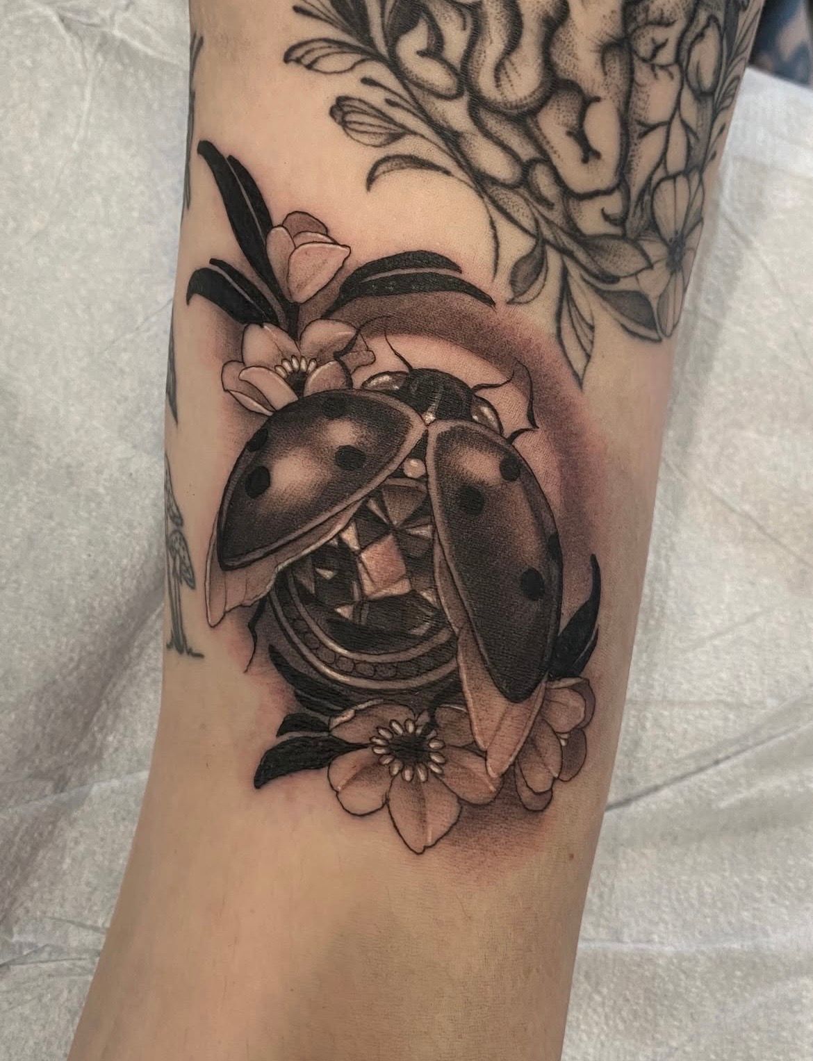 Jewelled Ladybug Tattoo by Sasha Day at Crimson Empire Tattoo in Edmonton Alberta Canada