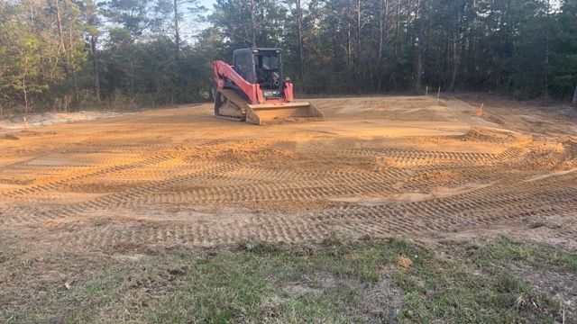 A bulldozer is moving dirt in a field.