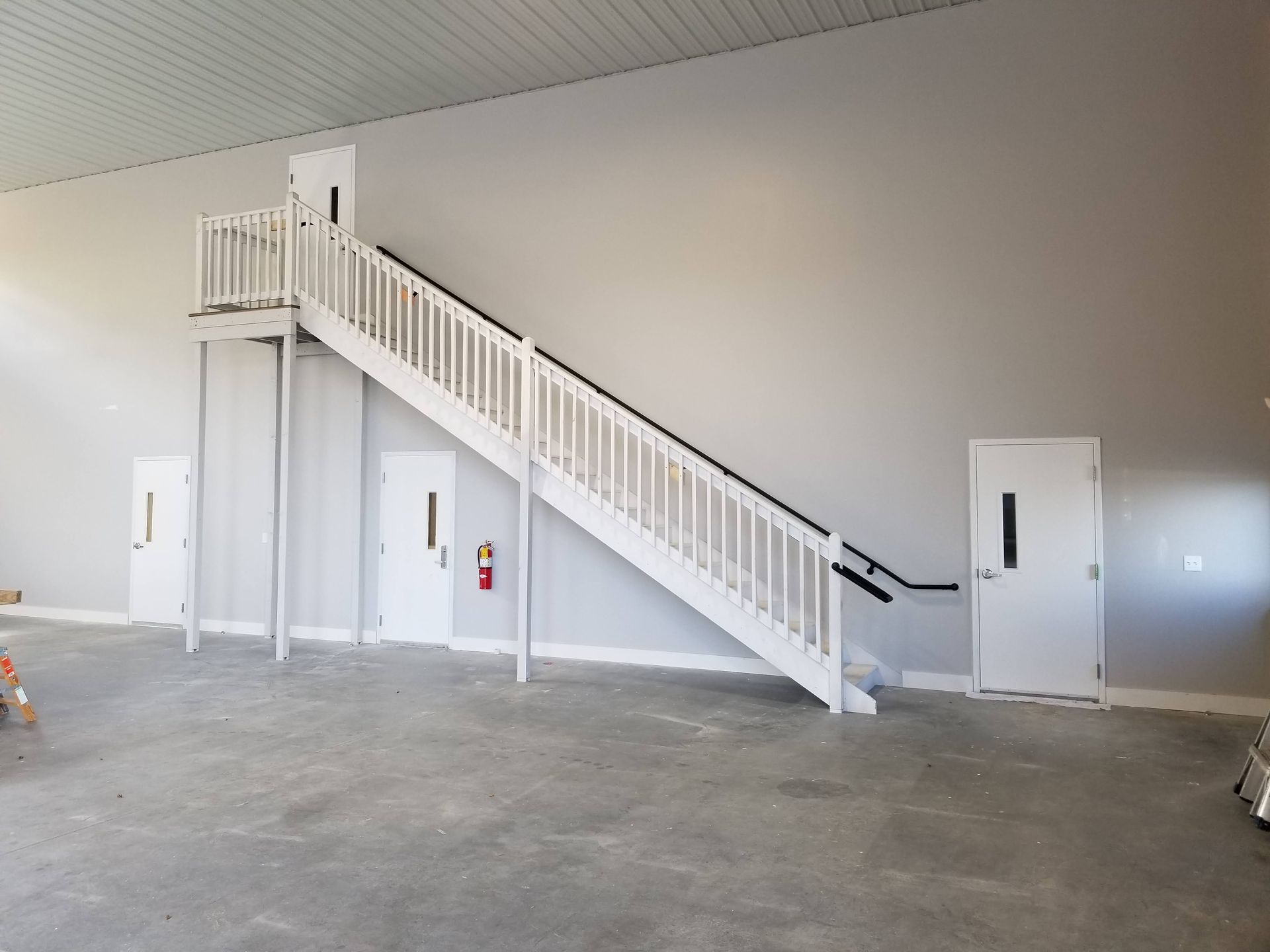 Two men are shaking hands in a warehouse.