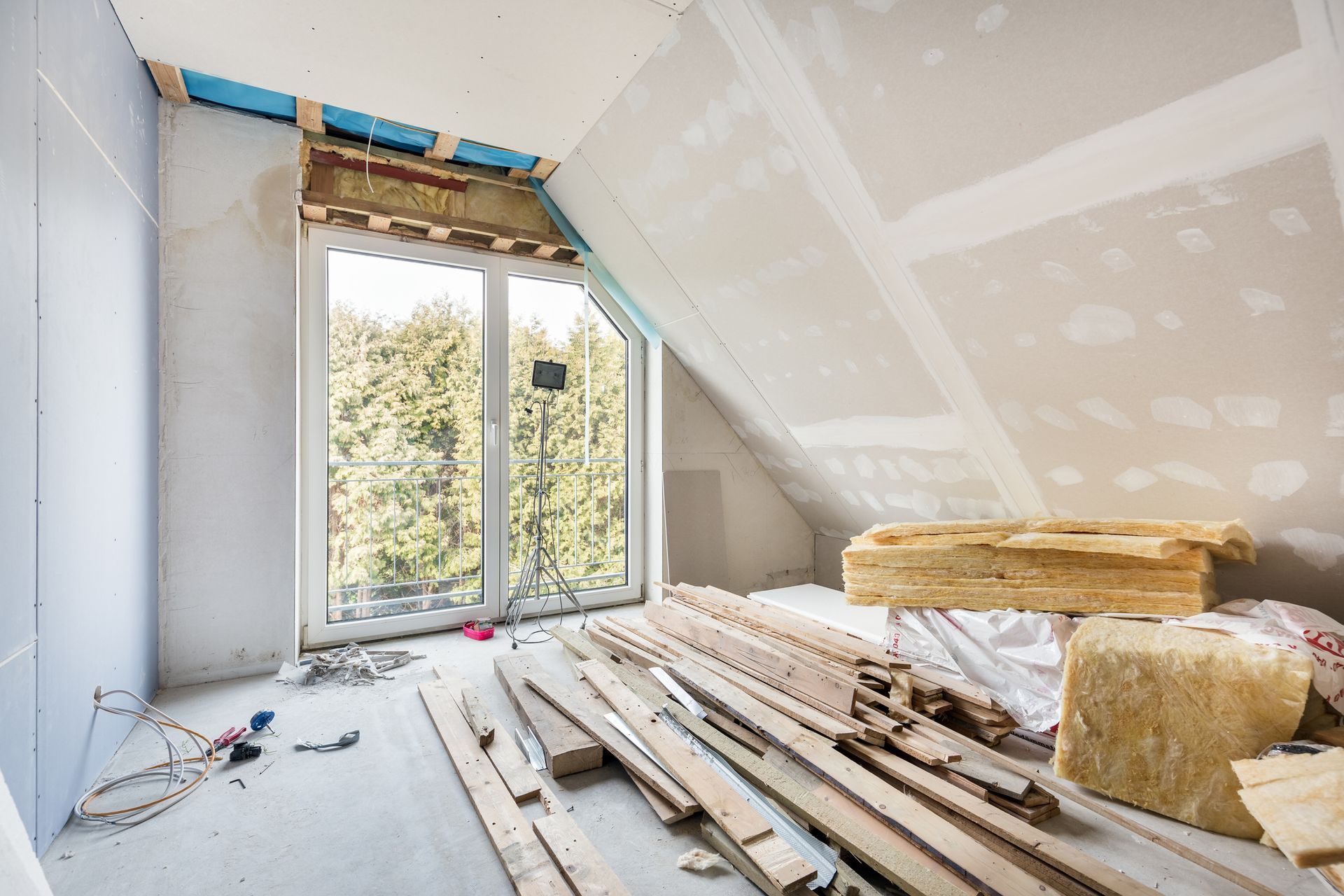 A room under construction with a lot of wood and a window.