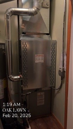 A stainless steel air conditioner is sitting in a room next to a door.