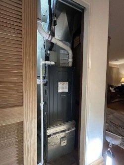 An air conditioner is installed in a closet in a house.