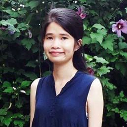 A young Vietnamese professional poses for a portrait photo for a website