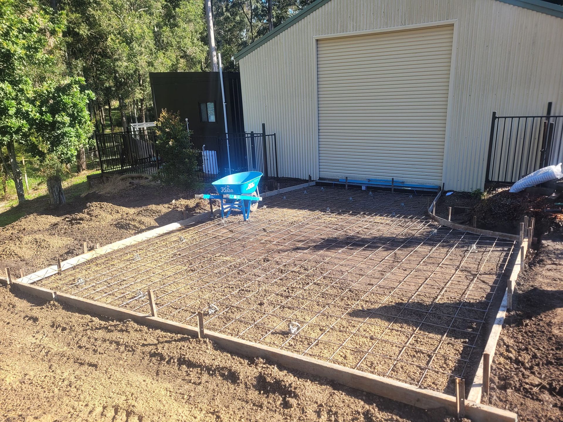 Blue Wheelbarrow on the Slab Foundation — Kempsey Concrete Contractors In Kempsey, NSW