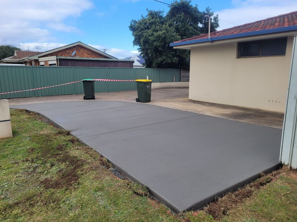Concrete Driveway and Two Garbage Bin — Kempsey Concrete Contractors In Kempsey, NSW