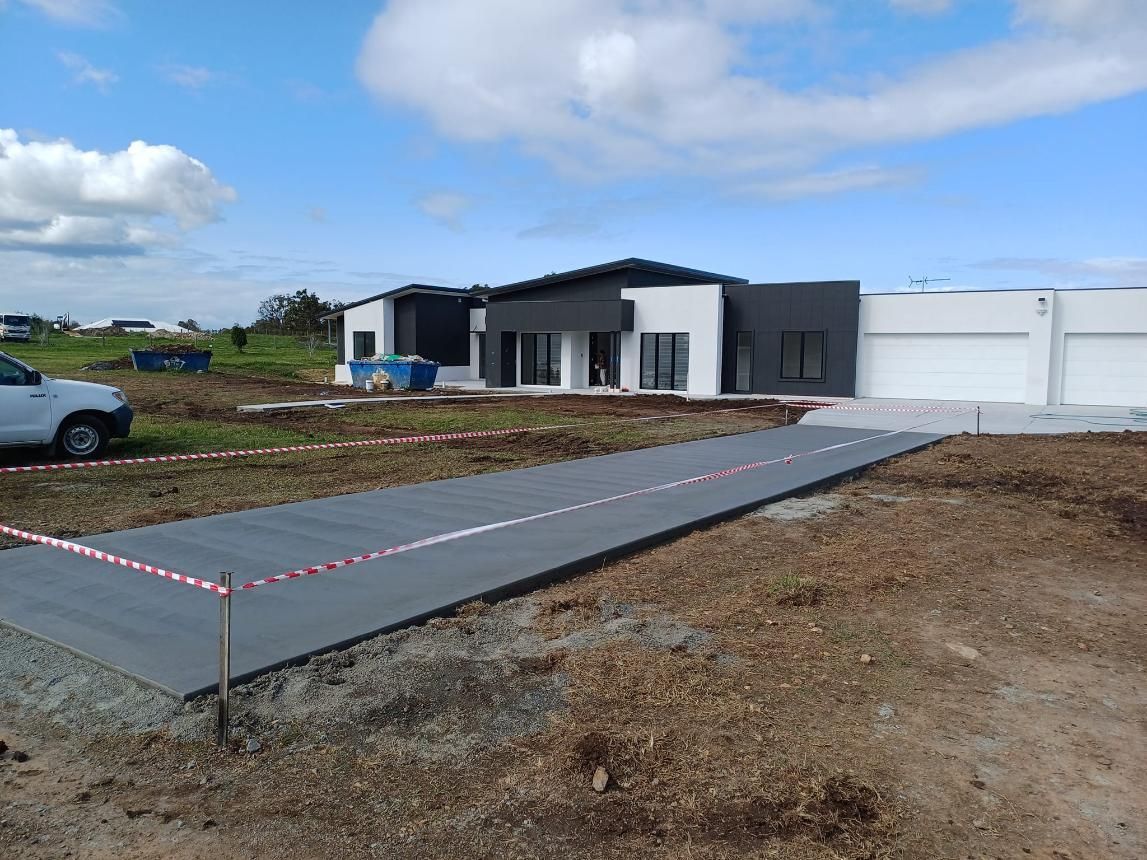 New Home Construction Site With Concrete Driveway — Kempsey Concrete Contractors In Port Macquarie, NSW