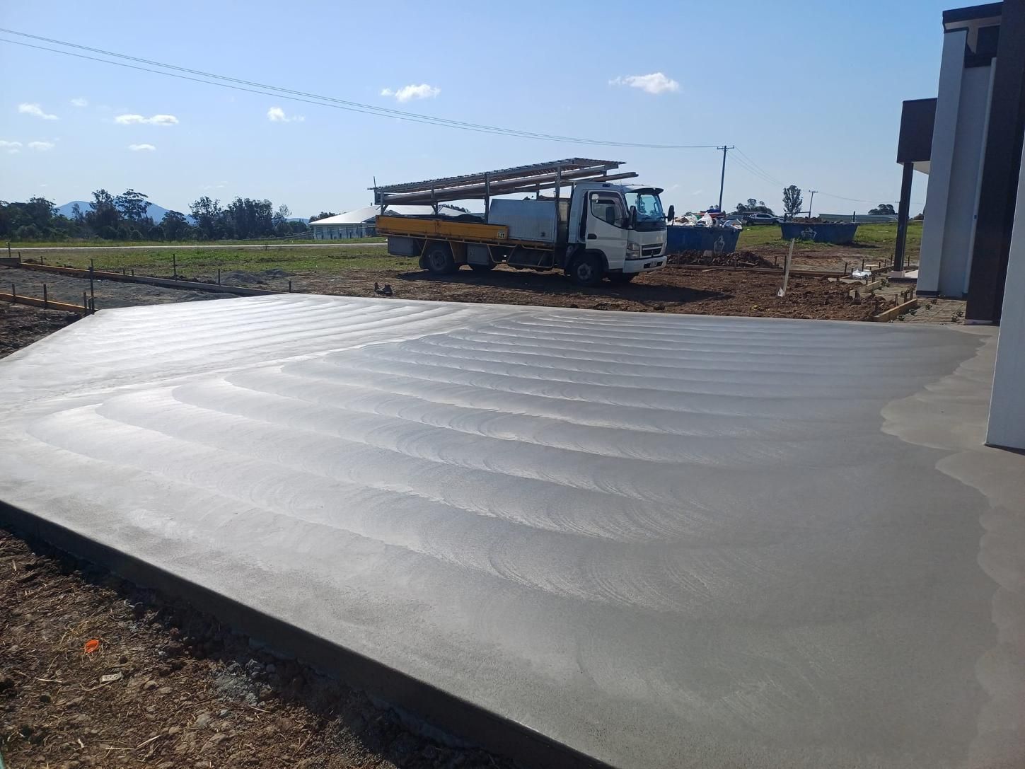 Freshly Poured Concrete Driveway, Next to a Building — Kempsey Concrete Contractors In Crescent Head, NSW