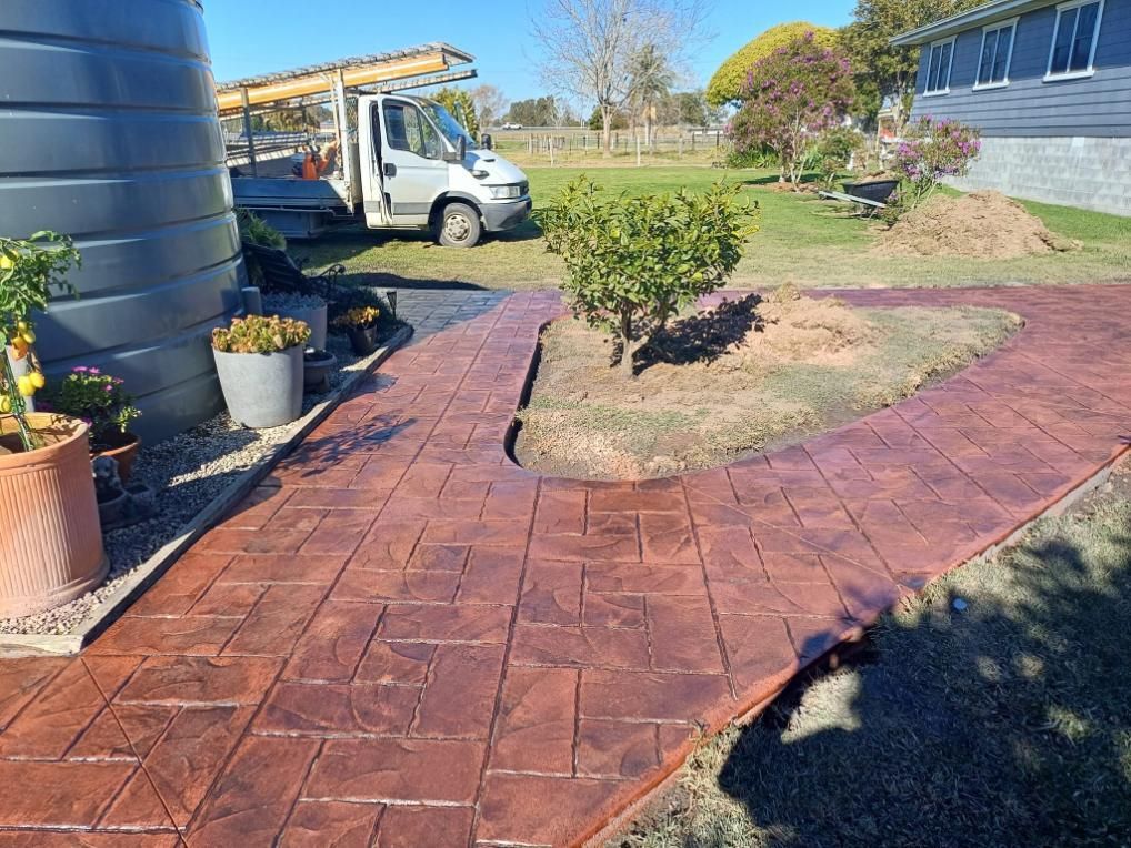 Brick-patterned, Reddish-brown Concrete Pathway Curves Through a Yard — Kempsey Concrete Contractors In Macksville, NSW