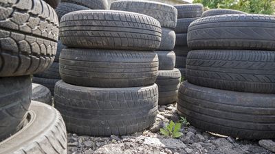 Old used car tires stacked in piles — Mayfield, KY — Hawkins Of Mayfield Inc