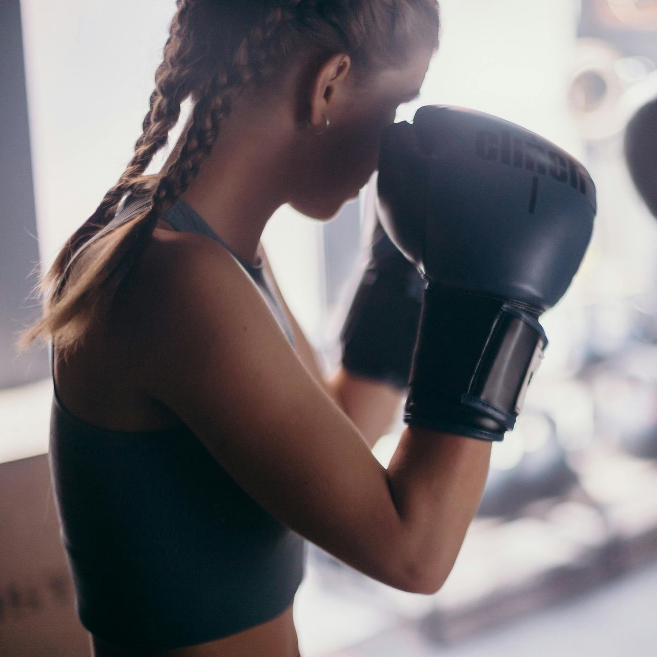 A woman wearing boxing gloves with the number 1 on them