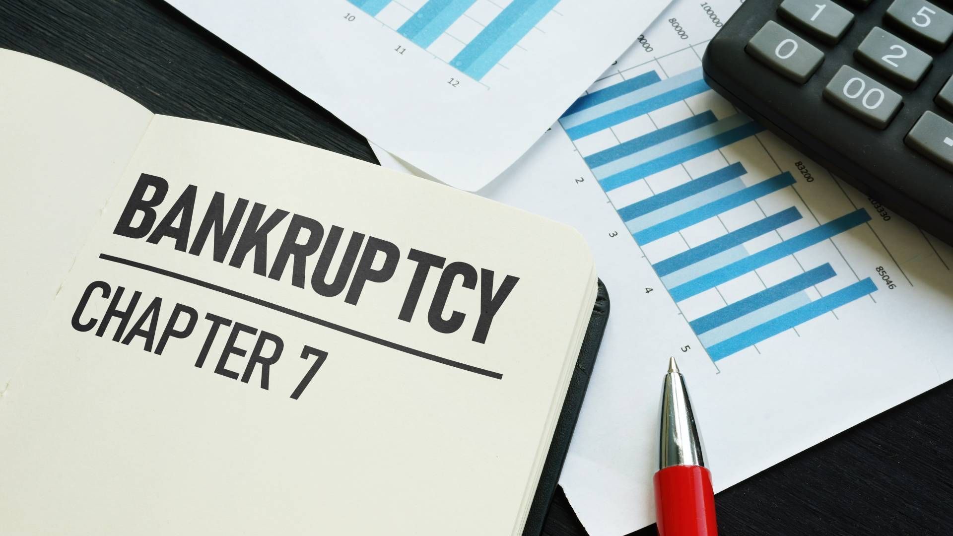 A pen is sitting on top of a piece of paper that says bankruptcy chapter 7.
