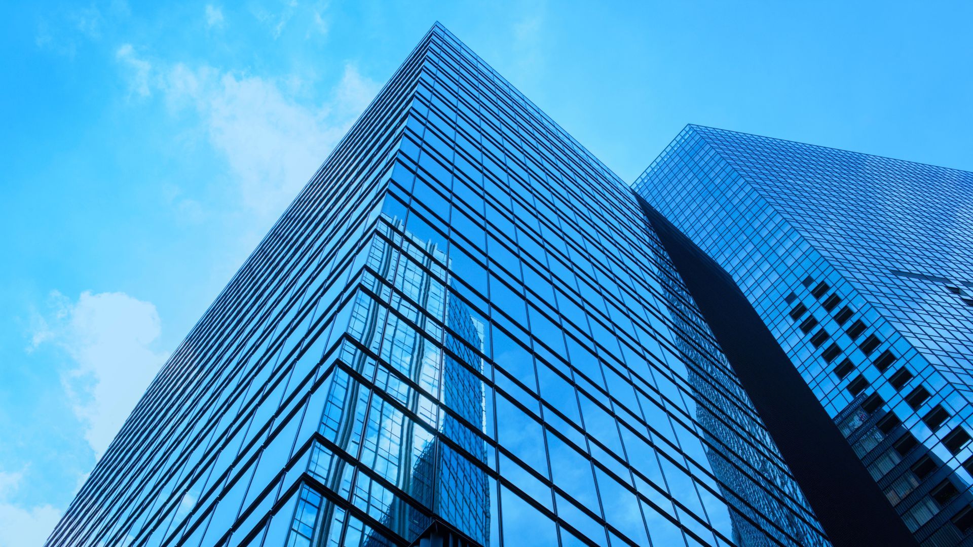 Looking up at a tall building with a blue sky in the background.