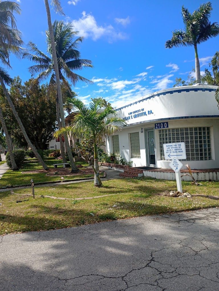 A white house with palm trees in front of it