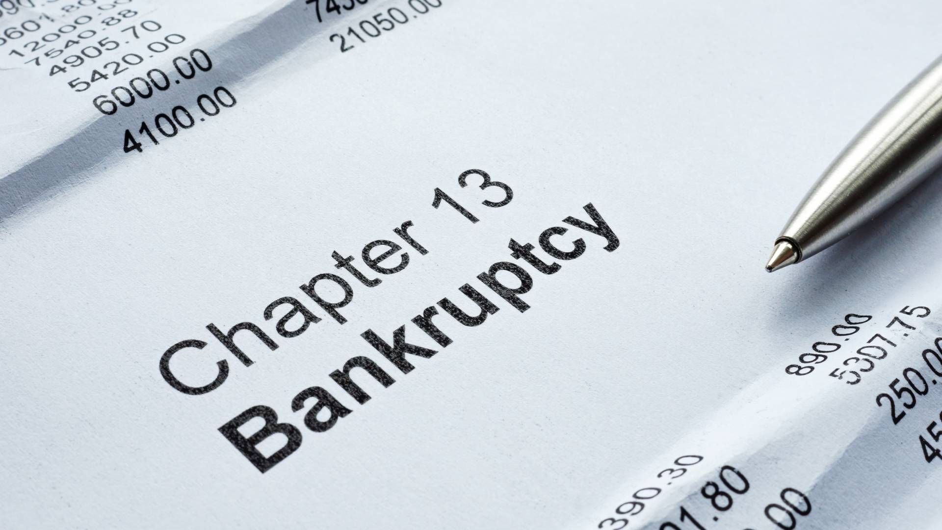 A pen is sitting on top of a piece of paper that says chapter 13 bankruptcy